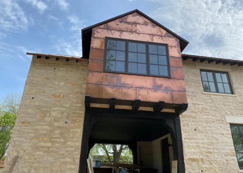 Copper metal panel facade on a stone building for Skylight Installation in Hot Springs